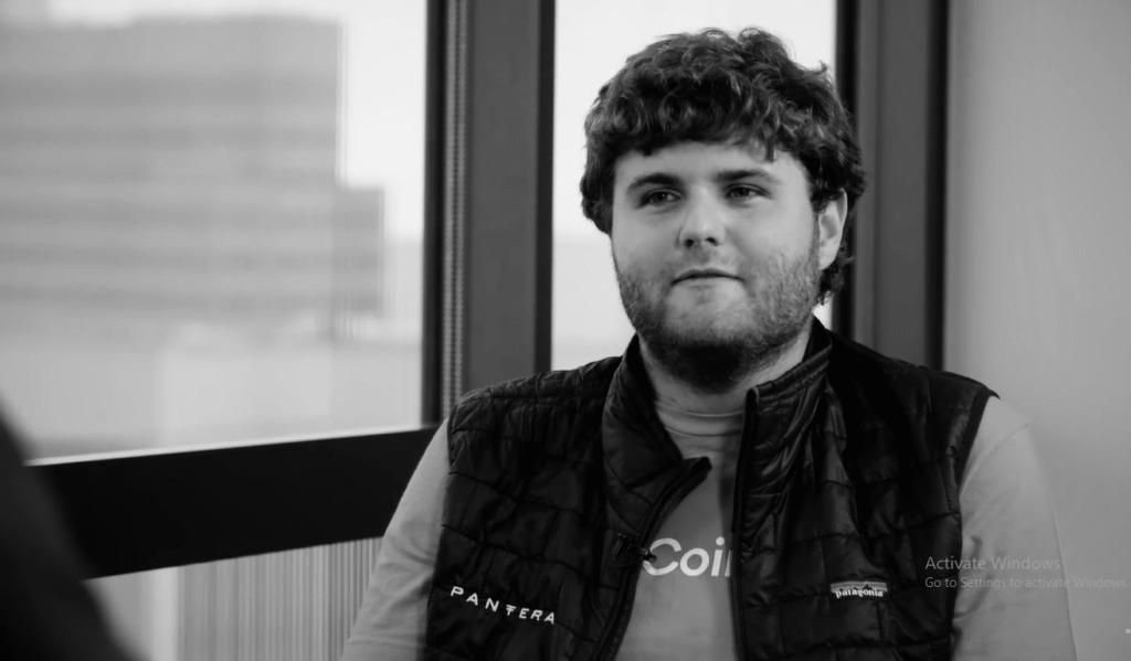 Joey Krug speaking at a crypto event, symbolizing his leadership in building a DeFi empire and shaping the future of decentralized finance in the U.S.