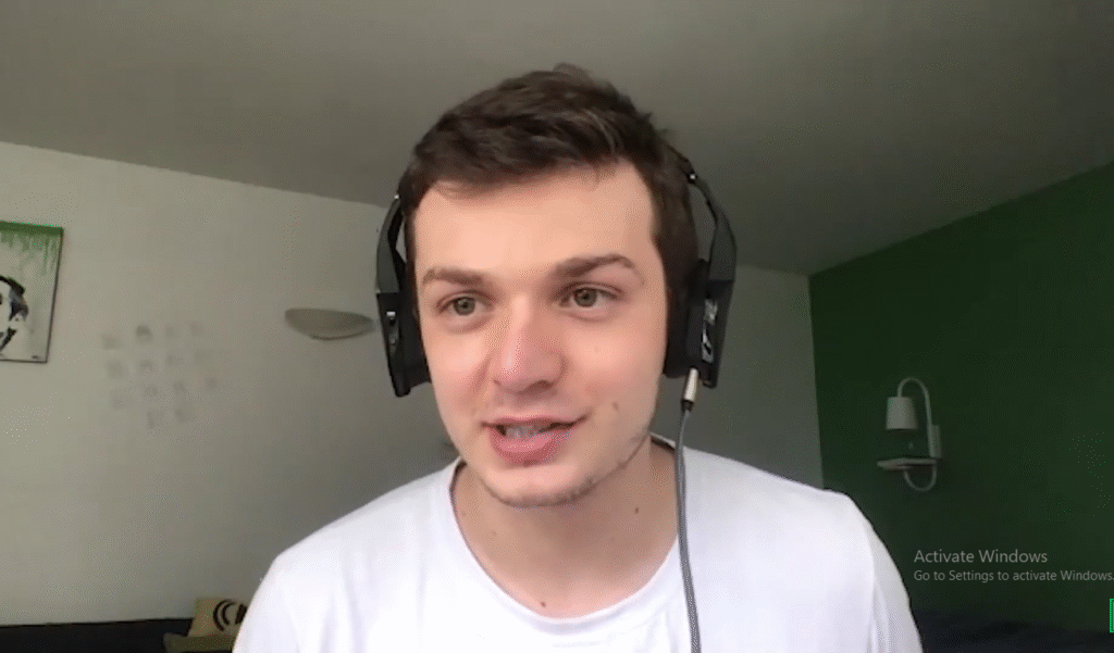 Alex Masmej, creator of the $ALEX token, known for launching the first human IPO in 2025, smiling confidently at a tech event