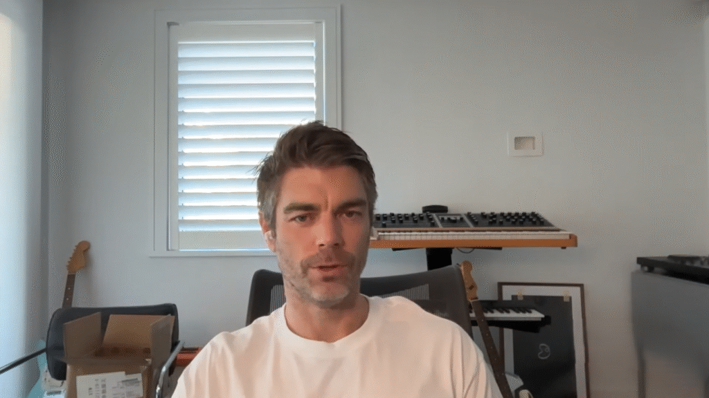 Kain Warwick speaking at a crypto event, founder of Synthetix and pioneer in DeFi, known for building a billion-dollar decentralized finance empire.